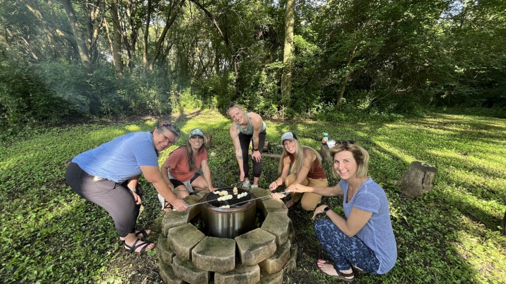 pediatric occupational therapists cooking biscuits over the fire