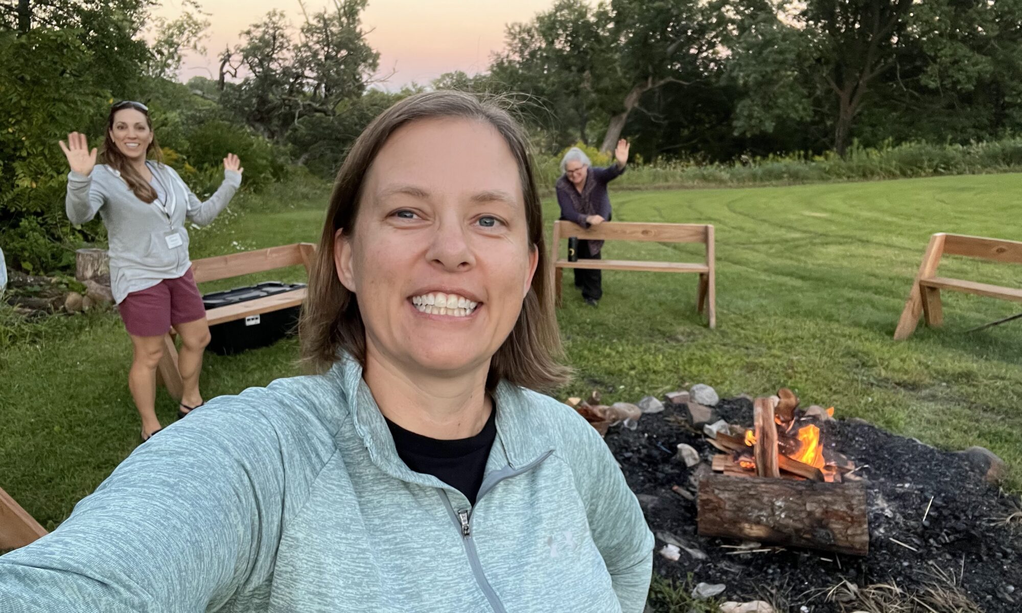 Nature based therapists posing for a photo around the fire at the therapist retreat called Grounded to Grow